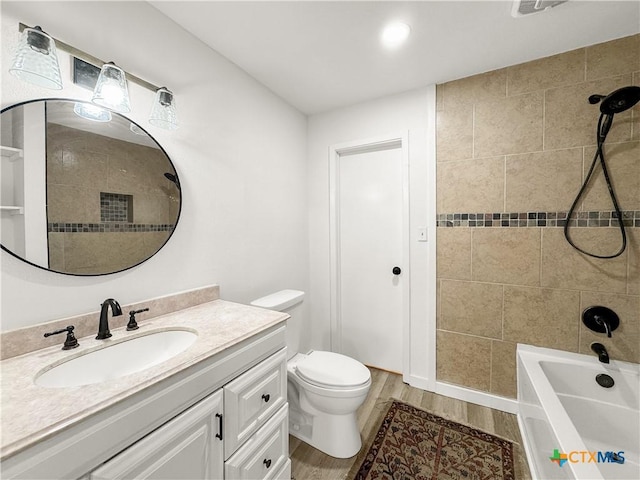 1412 Laurie Dr, Canyon Lake, TX 78133 - full bathroom with vanity, toilet, shower / bathtub combination, and wood finished floors