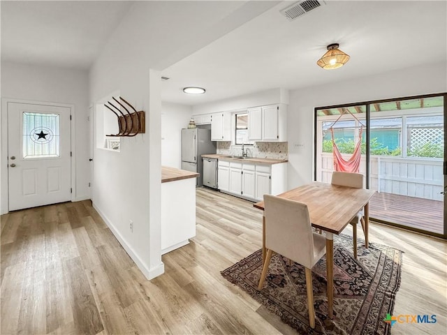 1412 Laurie Dr, Canyon Lake, TX 78133 - dining space featuring plenty of natural light, light wood-type flooring, and baseboards