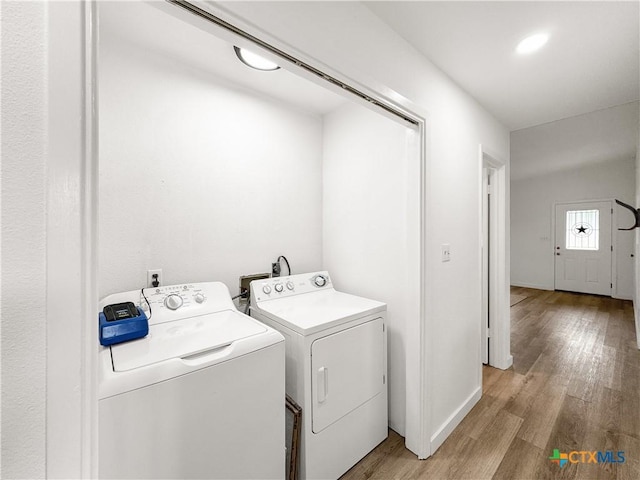 1412 Laurie Dr, Canyon Lake, TX 78133 - laundry room with independent washer and dryer, light wood-type flooring, and baseboards