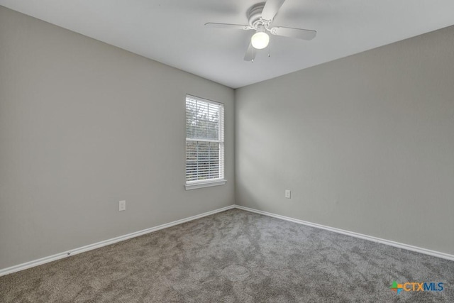 carpeted spare room featuring ceiling fan