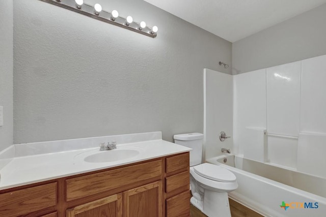 full bathroom with vanity,  shower combination, and toilet