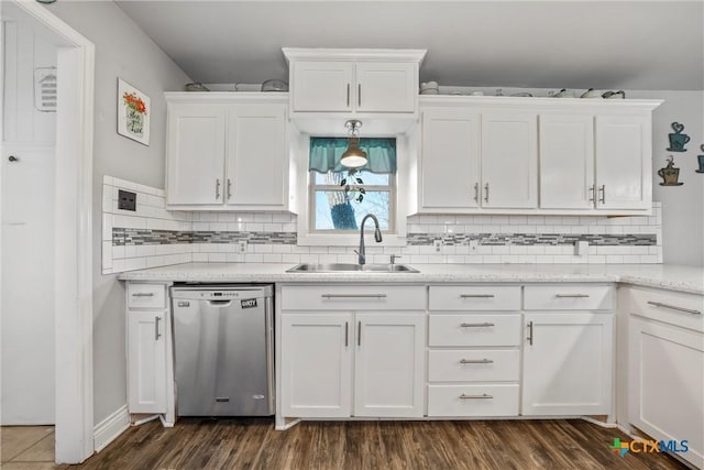 kitchen featuring white cabinetry, dishwasher, sink, and tasteful backsplash