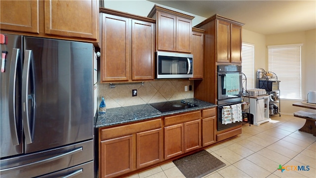 1906 Terry Dr, Copperas Cove, TX 76522 - kitchen featuring black appliances, decorative backsplash, brown cabinets, dark stone countertops, and light tile patterned floors