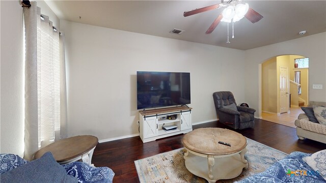 1906 Terry Dr, Copperas Cove, TX 76522 - living room featuring arched walkways, ceiling fan, wood finished floors, and baseboards