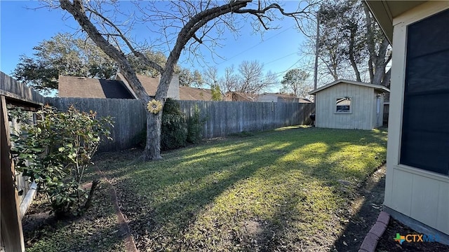 view of yard featuring a fenced backyard, a shed, and an outdoor structure