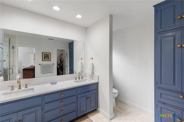 209 Full Moon, Horseshoe Bay, TX 78657 - bathroom featuring double vanity, a shower stall, toilet, baseboards, and a spacious closet