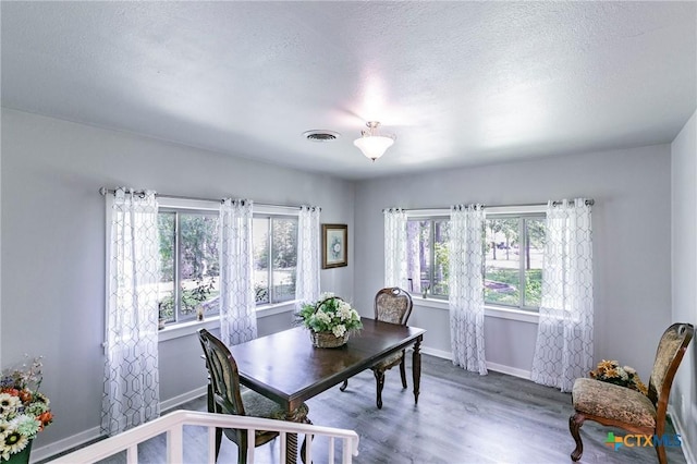 2518 Marlandwood Rd, Temple, TX 76502 - dining space featuring visible vents, baseboards, wood finished floors, and a textured ceiling