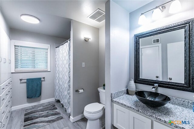 2518 Marlandwood Rd, Temple, TX 76502 - bathroom with toilet, vanity, baseboards, and visible vents
