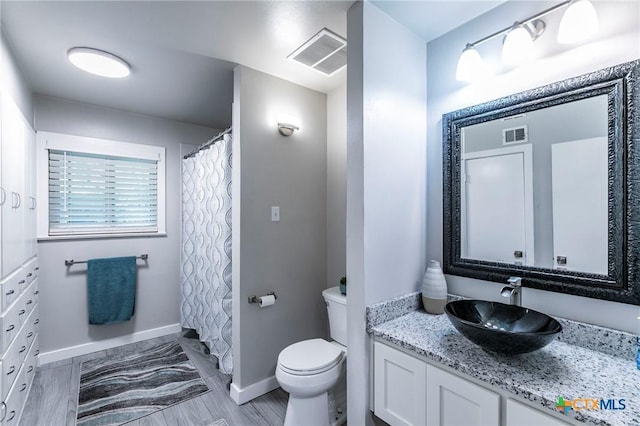 2518 Marlandwood Rd, Temple, TX 76502 - bathroom with toilet, vanity, baseboards, and visible vents