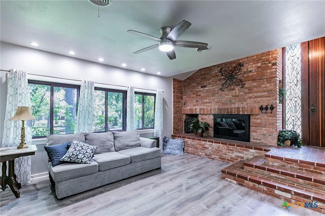 2518 Marlandwood Rd, Temple, TX 76502 - living area featuring visible vents, baseboards, a brick fireplace, ceiling fan, and wood finished floors