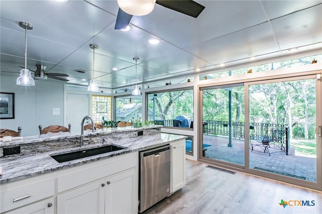 2518 Marlandwood Rd, Temple, TX 76502 - kitchen featuring light wood-style flooring, white cabinetry, a ceiling fan, stainless steel dishwasher, and a sink