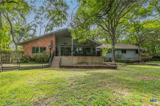 2518 Marlandwood Rd, Temple, TX 76502 - rear view of property featuring fence, brick siding, a ceiling fan, and a lawn