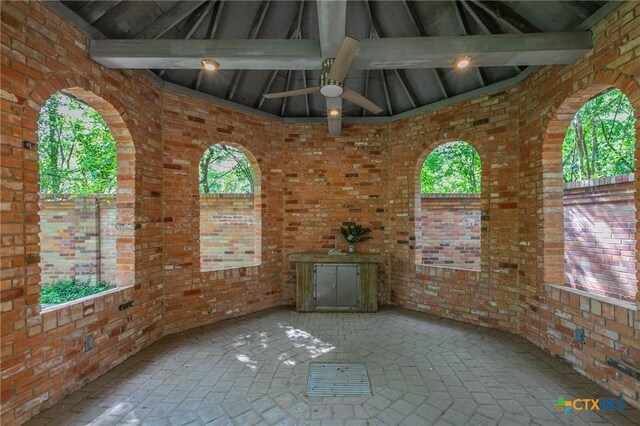 2518 Marlandwood Rd, Temple, TX 76502 - empty room with brick wall, brick floor, and beam ceiling