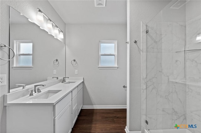 618 Seven Springs Dr, Temple, TX 76502 - bathroom featuring a sink, baseboards, plenty of natural light, and wood finished floors
