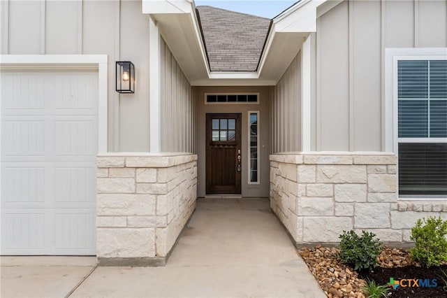 618 Seven Springs Dr, Temple, TX 76502 - view of exterior entry featuring roof with shingles, board and batten siding, a garage, and stone siding