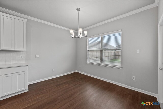 618 Seven Springs Dr, Temple, TX 76502 - unfurnished dining area with a chandelier, dark wood-style flooring, baseboards, and crown molding