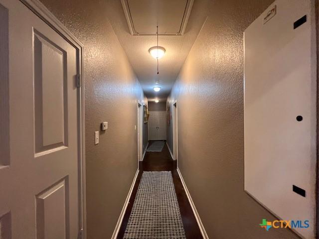 2800 S 3- A St, Waco, TX 76706 - hallway with attic access, baseboards, and a textured wall