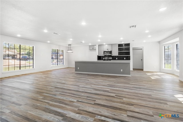 unfurnished living room with light hardwood / wood-style flooring