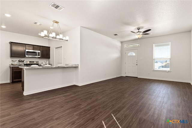 kitchen with visible vents, stainless steel appliances, baseboards, and dark wood-style flooring