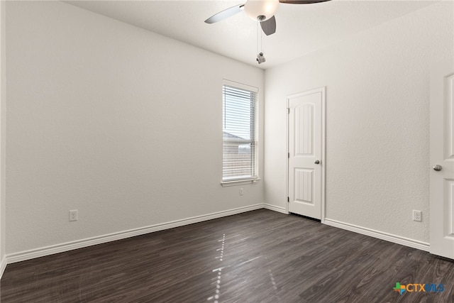 unfurnished room featuring ceiling fan, baseboards, and dark wood-style floors