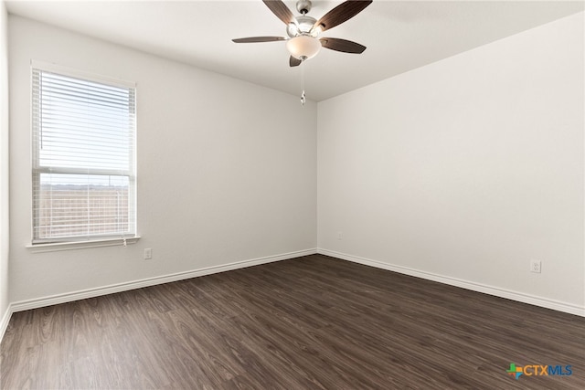 unfurnished room with dark wood-style floors, baseboards, and ceiling fan