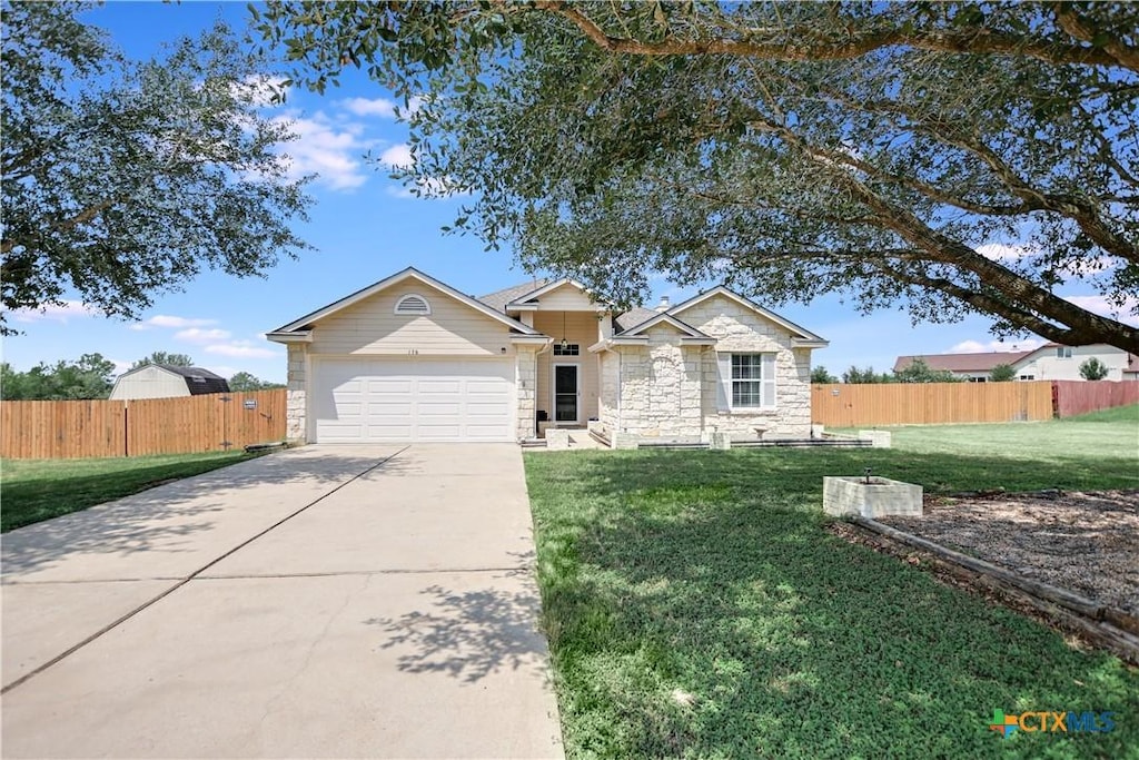 single story home featuring a garage and a front lawn