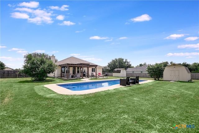 view of pool with a patio area, a shed, and a yard