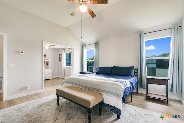 bedroom featuring light hardwood / wood-style floors, ceiling fan, and lofted ceiling