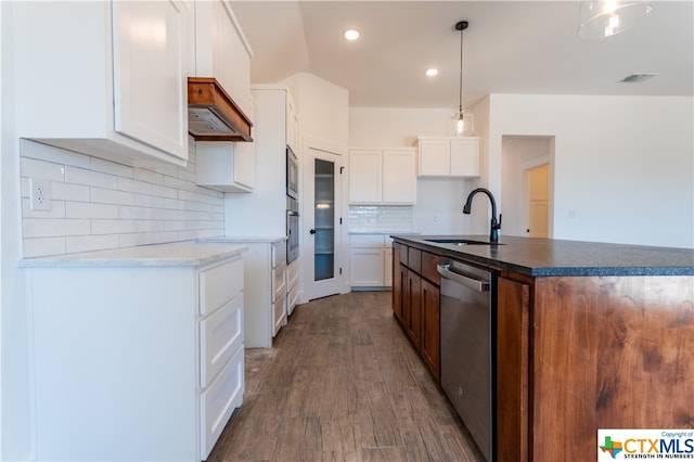 kitchen featuring white cabinetry, stainless steel appliances, hanging light fixtures, and dark hardwood / wood-style floors