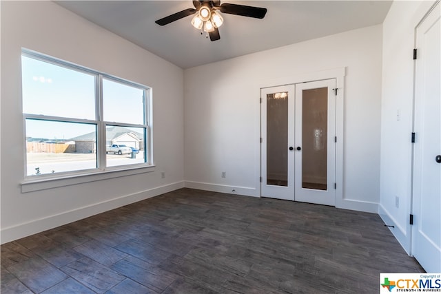 empty room with dark hardwood / wood-style flooring, ceiling fan, and french doors