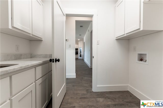 washroom featuring cabinets, washer hookup, and dark hardwood / wood-style floors