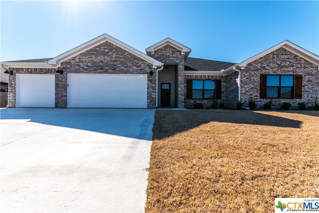 view of front of property with a garage and a front yard