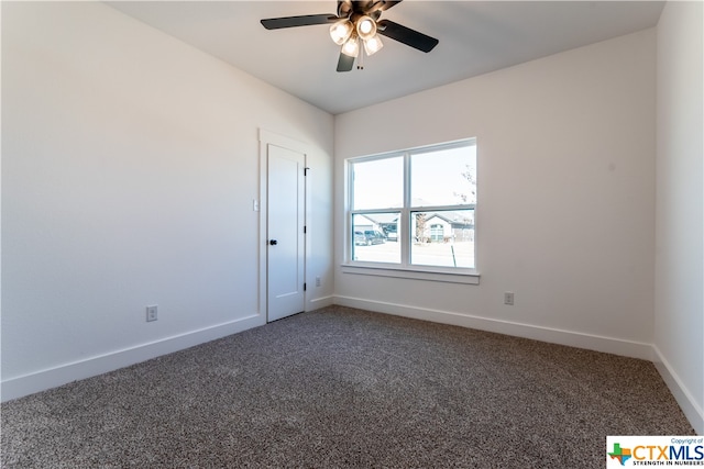 empty room featuring ceiling fan and dark carpet