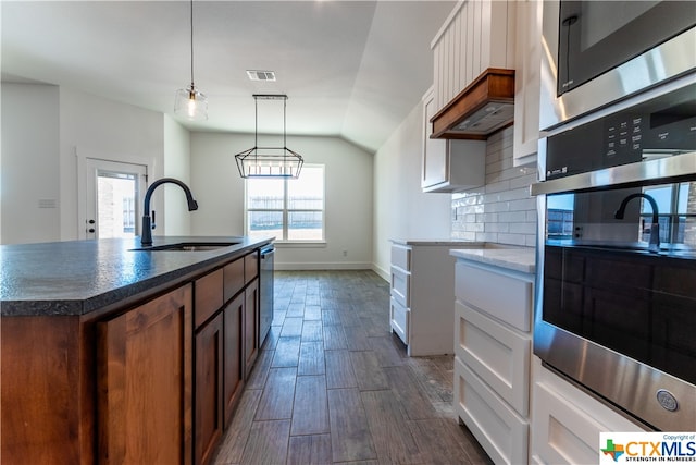 kitchen with white cabinets, a wealth of natural light, dark hardwood / wood-style floors, and decorative light fixtures