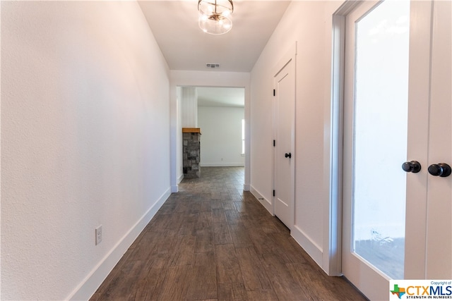 hallway featuring a chandelier and dark hardwood / wood-style flooring