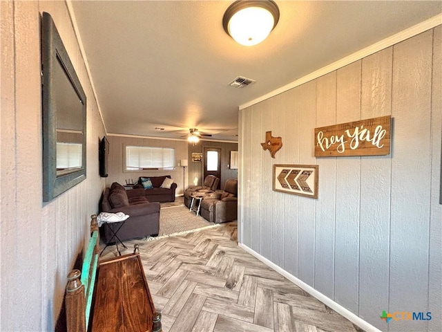 corridor with crown molding and light parquet floors