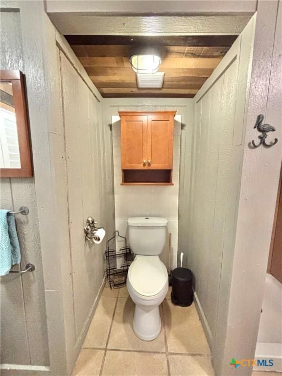 bathroom with toilet, tile patterned flooring, and wooden ceiling