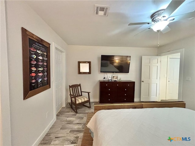 bedroom with ceiling fan and light wood-type flooring