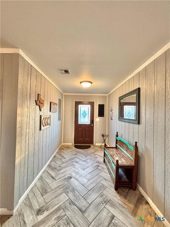 entryway featuring light parquet floors and ornamental molding