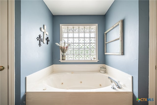 bathroom featuring a tub to relax in