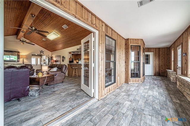 interior space featuring vaulted ceiling with beams, plenty of natural light, and wooden ceiling