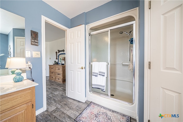 bathroom featuring vanity and an enclosed shower