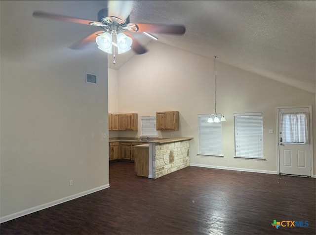 2421 Hornsby, Spring Branch, TX 78070 - unfurnished living room featuring ceiling fan, dark wood-style flooring, high vaulted ceiling, and a textured ceiling