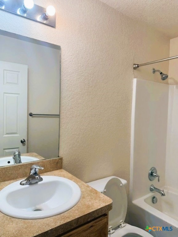 2421 Hornsby, Spring Branch, TX 78070 - bathroom featuring a textured wall, vanity, shower / bath combination, and a textured ceiling