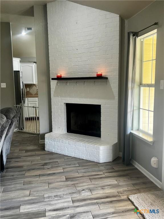 2005 Stonehenge Dr, Harker Heights, TX 76548 - detailed view of a fireplace, wood finished floors, and freestanding refrigerator