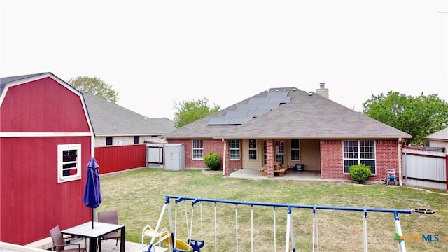 2005 Stonehenge Dr, Harker Heights, TX 76548 - back of house with brick siding, a fenced backyard, a patio, and roof mounted solar panels