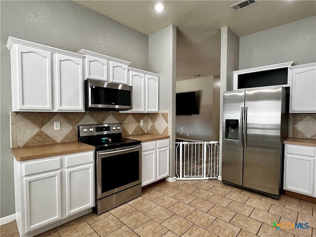 2005 Stonehenge Dr, Harker Heights, TX 76548 - kitchen featuring stainless steel appliances, white cabinets, and decorative backsplash