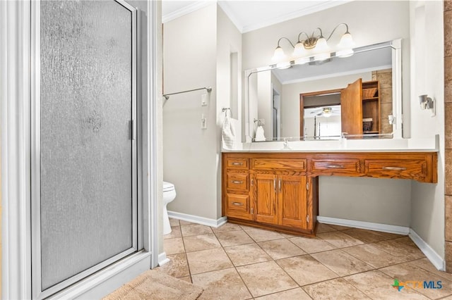 bathroom with tile patterned floors, vanity, a shower with door, crown molding, and toilet