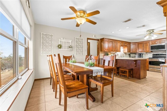 tiled dining room with ceiling fan and a healthy amount of sunlight