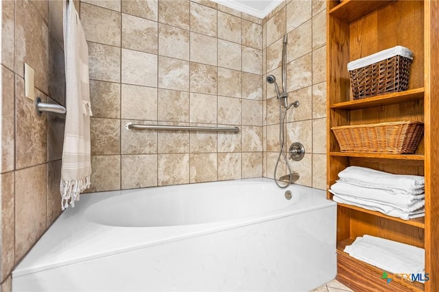 bathroom with tiled shower / bath combo and ornamental molding